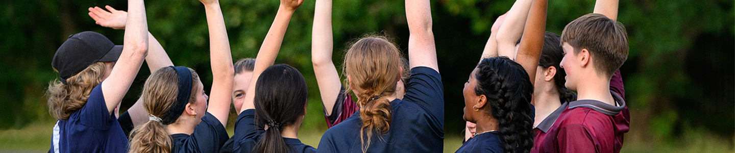 female sport team with hands raised